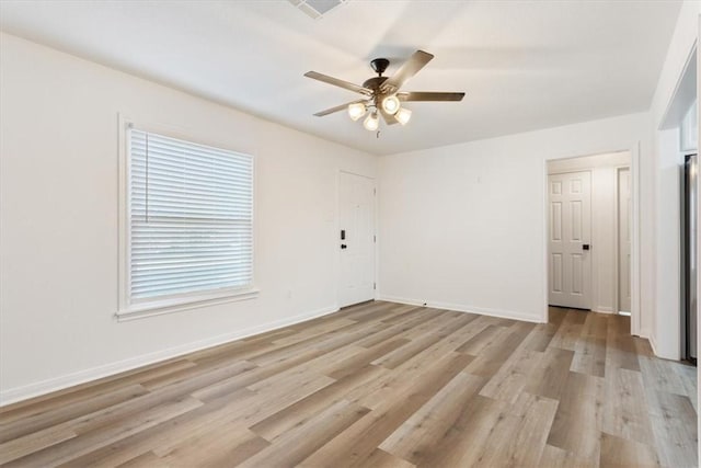 unfurnished room featuring ceiling fan and light wood-type flooring