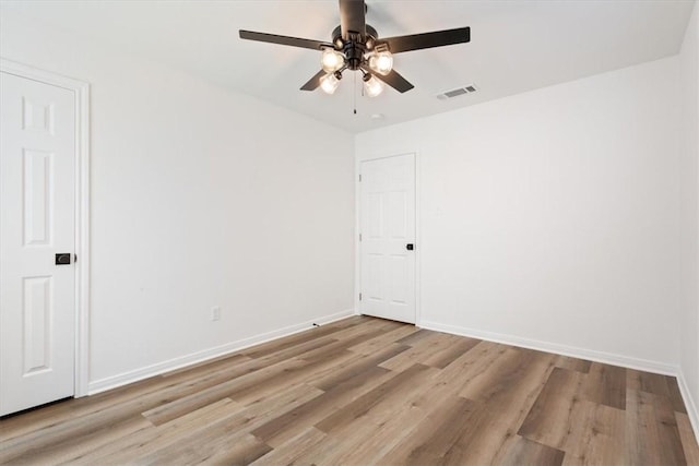 empty room with light wood-type flooring and ceiling fan