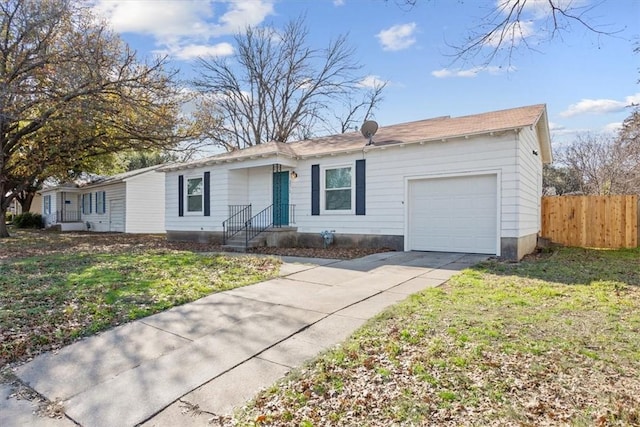 ranch-style house featuring a front yard and a garage