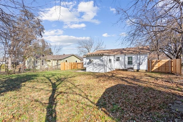 rear view of property featuring a lawn