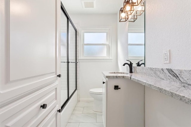 full bathroom featuring toilet, tile patterned flooring, combined bath / shower with glass door, and vanity