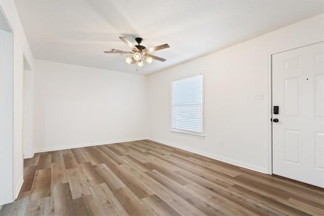 empty room with light wood-type flooring and ceiling fan