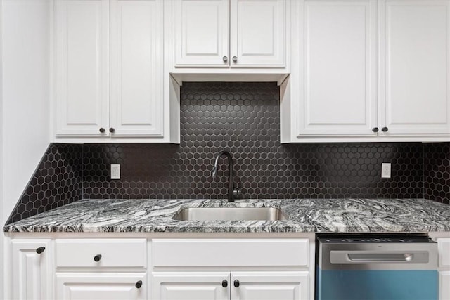 kitchen featuring sink, white cabinetry, dishwasher, and tasteful backsplash