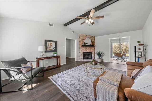 living room with dark wood-type flooring, a brick fireplace, vaulted ceiling with beams, and visible vents