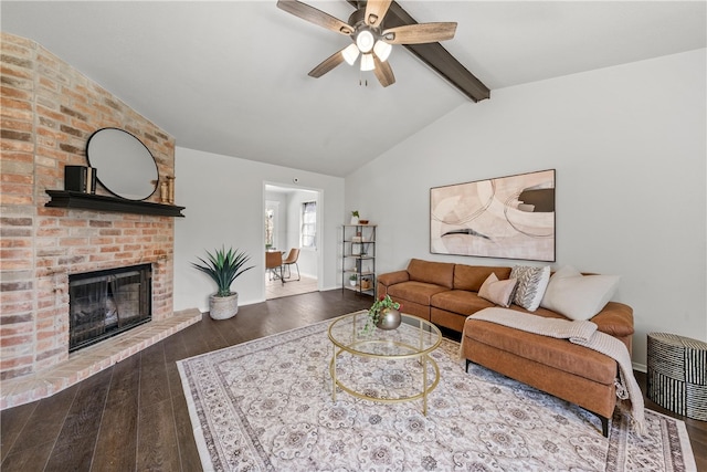 living area with a fireplace, vaulted ceiling with beams, baseboards, and hardwood / wood-style floors