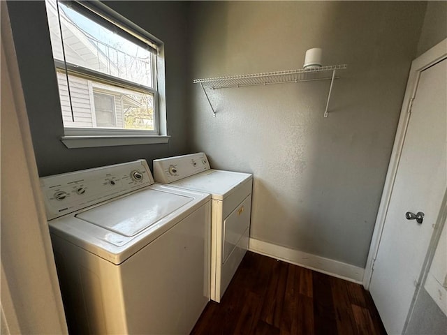 laundry area featuring laundry area, baseboards, dark wood finished floors, and independent washer and dryer