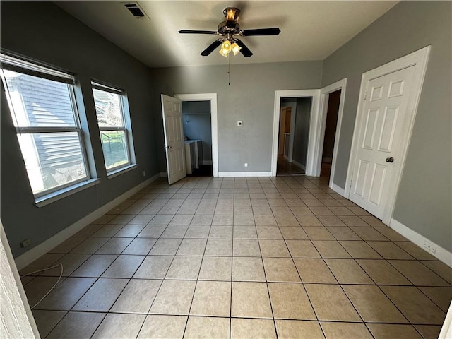 unfurnished bedroom featuring visible vents, ceiling fan, baseboards, and light tile patterned flooring