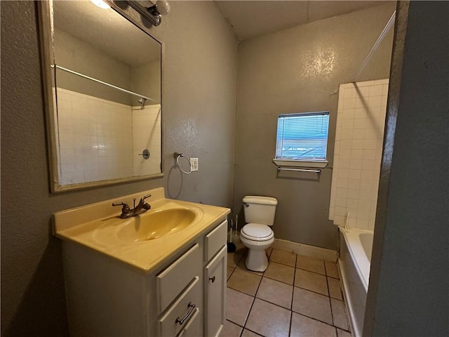 bathroom featuring baseboards, bathing tub / shower combination, toilet, tile patterned flooring, and vanity