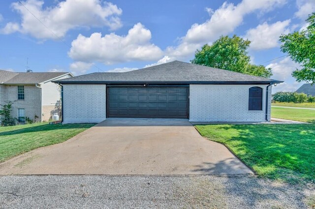 view of front of house with a front yard and a garage