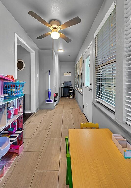 recreation room with tile patterned flooring and ceiling fan