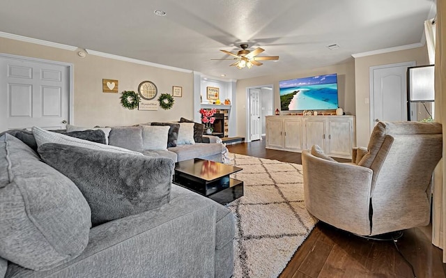 living room with dark hardwood / wood-style floors, ceiling fan, and ornamental molding