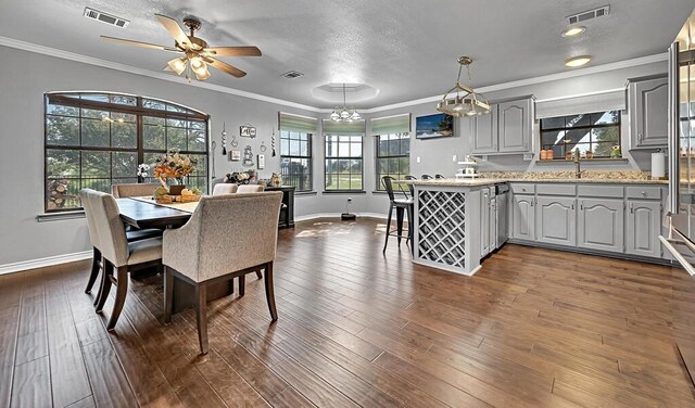 dining area featuring a healthy amount of sunlight and dark hardwood / wood-style flooring