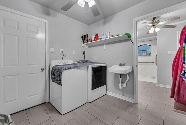 laundry area with washing machine and dryer, ceiling fan, and sink