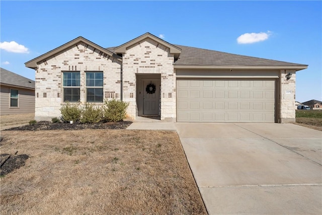 view of front of home with a garage, stone siding, driveway, and a shingled roof