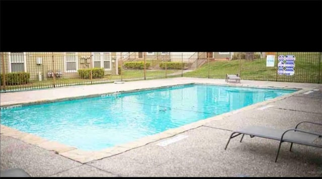 pool featuring a patio and fence