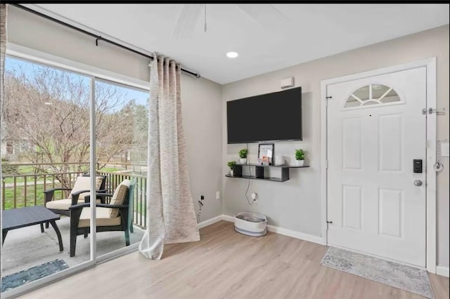 foyer entrance featuring baseboards and wood finished floors