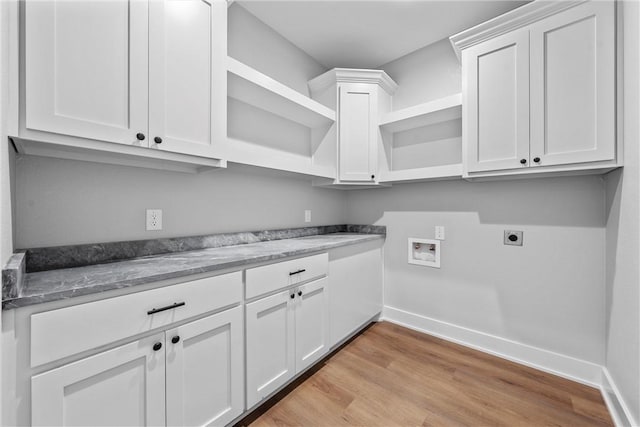 laundry room with hookup for a washing machine, cabinet space, light wood-style floors, hookup for an electric dryer, and baseboards