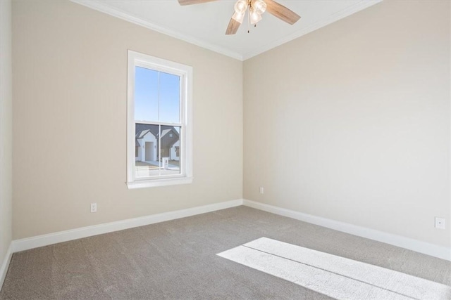 carpeted spare room featuring ceiling fan and ornamental molding