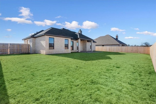 rear view of property with a yard