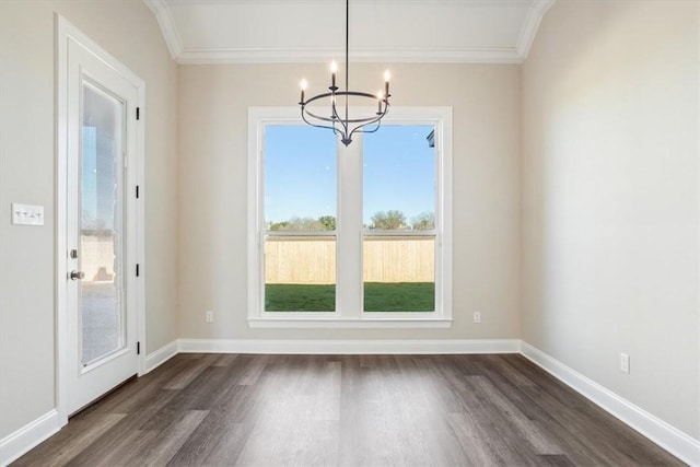 unfurnished dining area with dark hardwood / wood-style flooring, an inviting chandelier, and ornamental molding