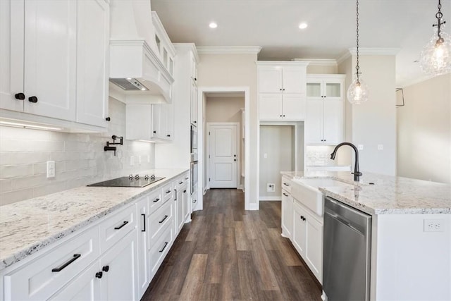 kitchen featuring black electric cooktop, dishwasher, white cabinets, and decorative light fixtures