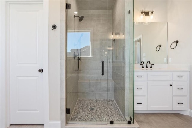 bathroom with tile patterned flooring, vanity, and a shower with shower door