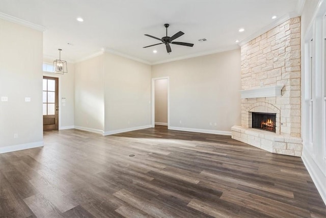 unfurnished living room with a fireplace, ceiling fan, crown molding, and dark wood-type flooring