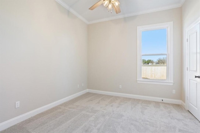 spare room with light colored carpet, ceiling fan, and crown molding