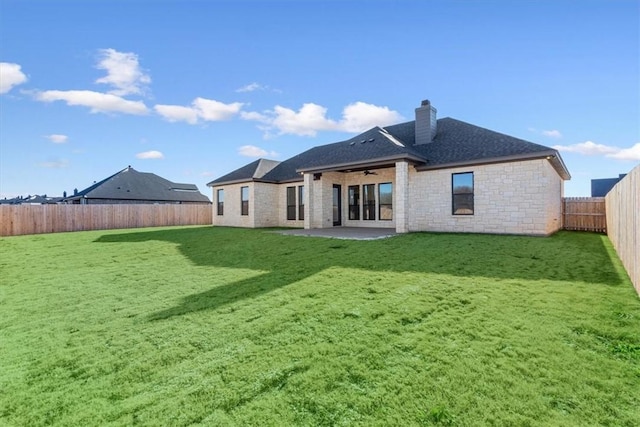 rear view of house featuring a patio, ceiling fan, and a lawn