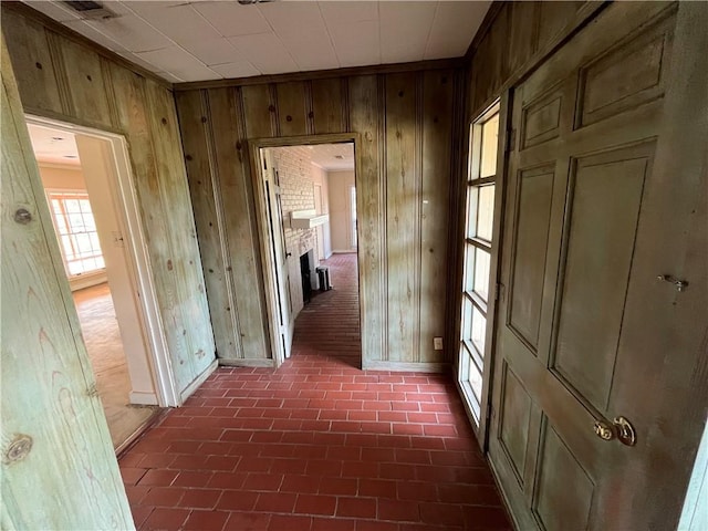 hallway with wood walls