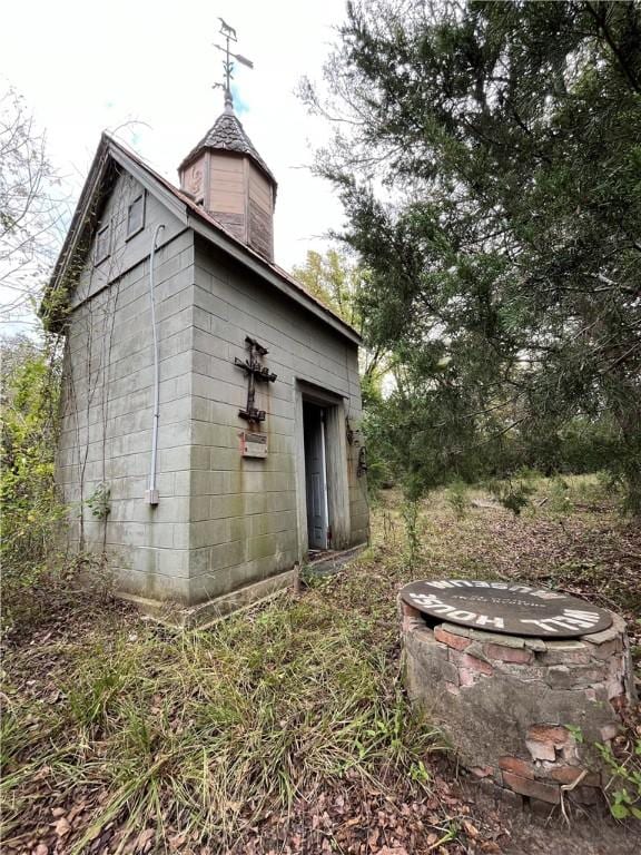 view of home's exterior with an outbuilding