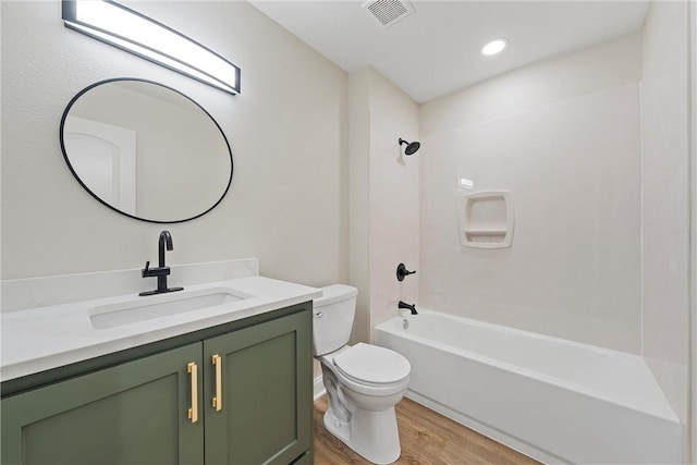 full bathroom with vanity, wood-type flooring, bathing tub / shower combination, and toilet