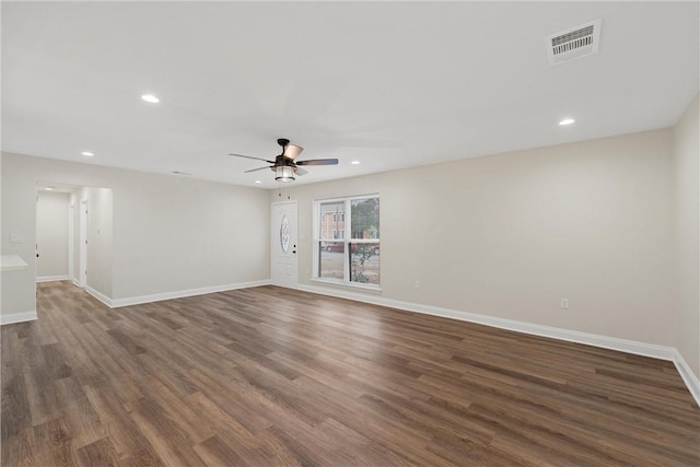 unfurnished room featuring ceiling fan and dark wood-type flooring