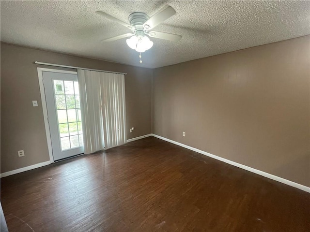 empty room with dark hardwood / wood-style flooring, ceiling fan, and a textured ceiling