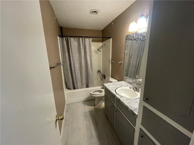 full bathroom featuring a textured ceiling, vanity, toilet, and shower / bath combo