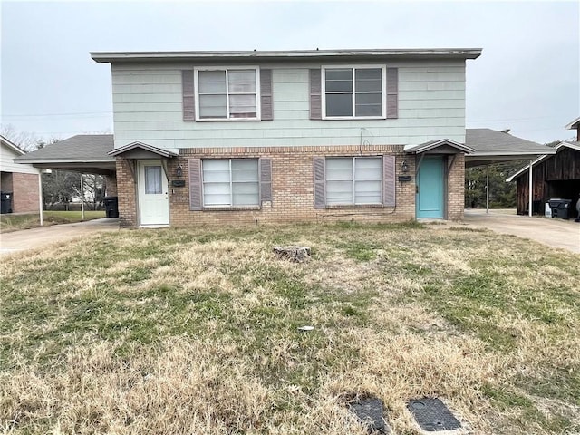 view of front facade with a carport and a front yard