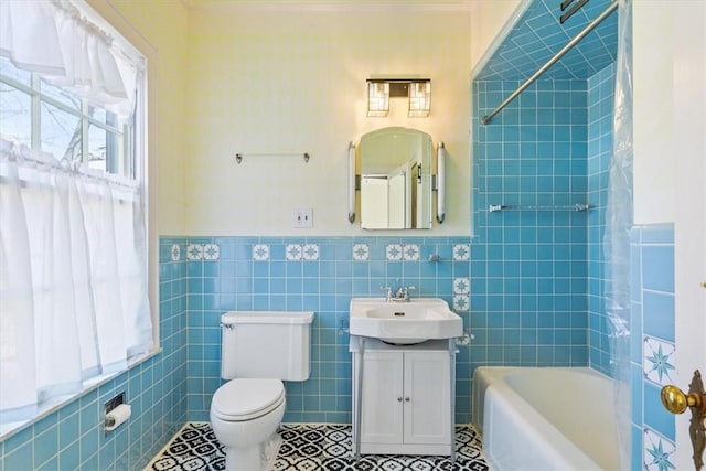 full bath with tile patterned floors, toilet, tile walls, wainscoting, and vanity