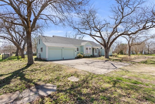 single story home featuring an attached garage, driveway, and fence