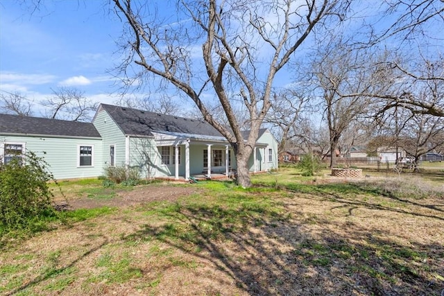 back of house featuring fence and covered porch