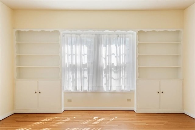 empty room featuring wood finished floors and baseboards