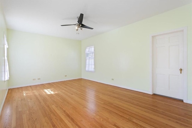 unfurnished room with baseboards, light wood-style floors, and a ceiling fan