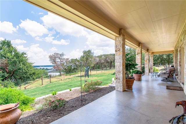 view of patio with a water view