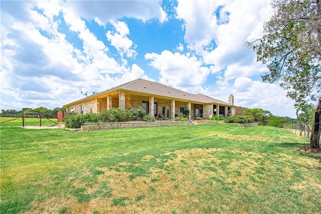 rear view of property with a yard