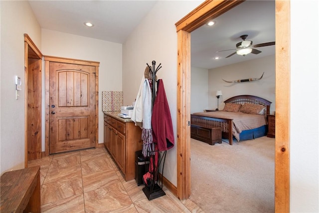 interior space with light colored carpet and ceiling fan