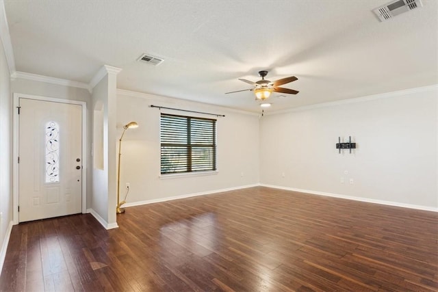 foyer with baseboards, visible vents, dark wood finished floors, and crown molding