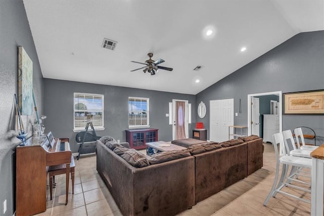 living room featuring light tile patterned floors, vaulted ceiling, and ceiling fan