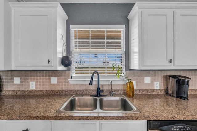 kitchen with dishwasher, decorative backsplash, sink, and white cabinets