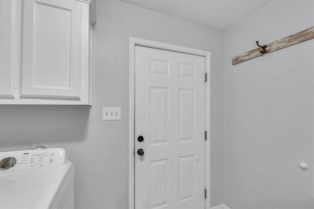 washroom featuring washer / clothes dryer and cabinets