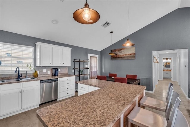 kitchen featuring dishwasher, decorative light fixtures, a kitchen island, and sink