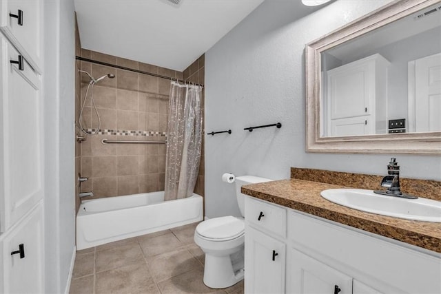 full bathroom with tile patterned floors, shower / tub combo with curtain, vanity, and toilet